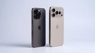 A pristine iPhone standing upright with a soft blue motion streak behind it on a clean studio surface