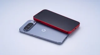 An iPhone, a Samsung Galaxy and a Google Pixel standing side by side on a clean studio surface