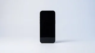 A refurbished iPhone and Google Pixel lying side by side on a clean studio surface, seen from above