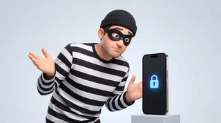 A comically baffled burglar in a stripey top and eye mask staring at a locked phone on a clean studio surface